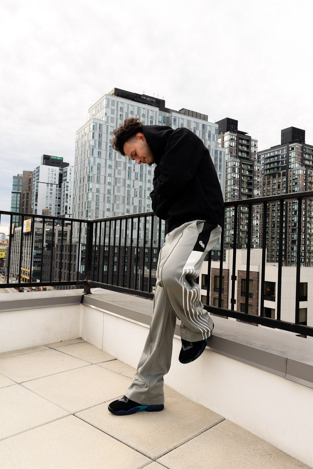 Person standing on a rooftop with city skyline in the background